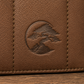 Close-up of the brown textured leather Bonsai bag, featuring a circular embossed logo of a bonsai tree on the front panel.